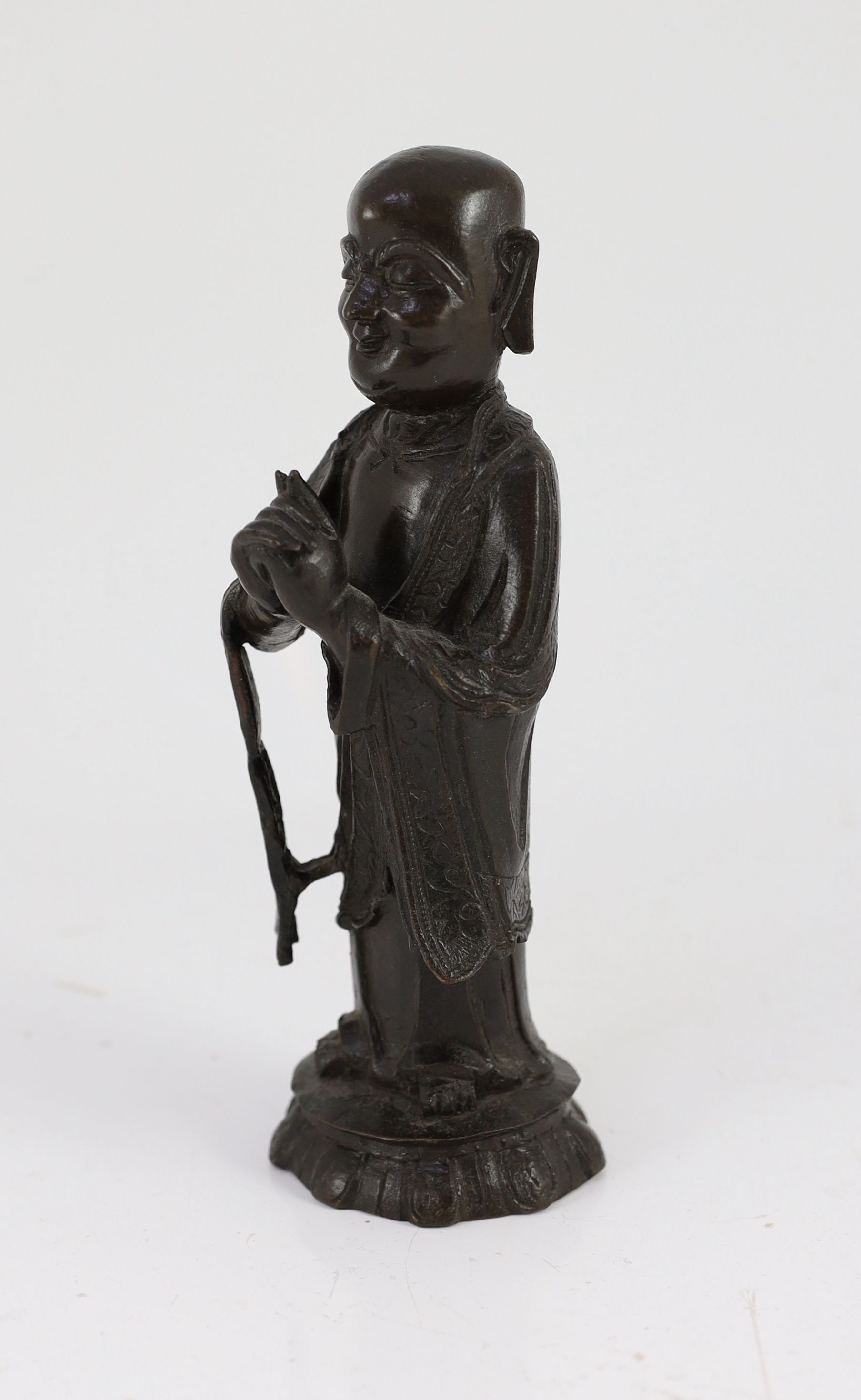 A Chinese Ming bronze figure of a luohan, 17th century, 21cm high